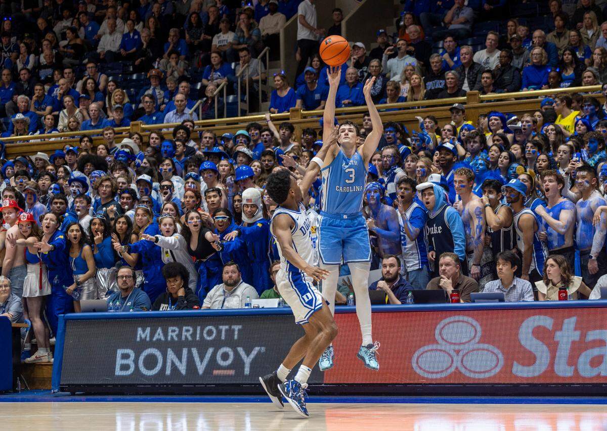 North Carolina’s Cormac Ryan (3) launches a three point shot over Duke’s Jeremy Roach (3) in the second half on Saturday, March 9, 2024 at Cameron Indoor Stadium in Durham, N.C. Ryan scored 31 points in the Tar Heels’ 84-79 victory.