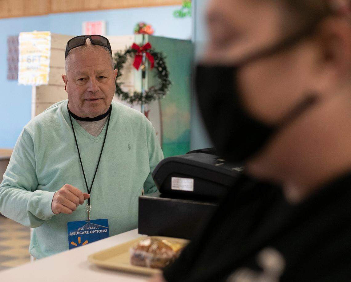 Richard Ghoens pays his tab after having lunch at the Nashville Diner in Nashville, N.C. on Wednesday, December 2, 2020. Ghoens said he doesn’t believe he should be forced to wear a face covering.
