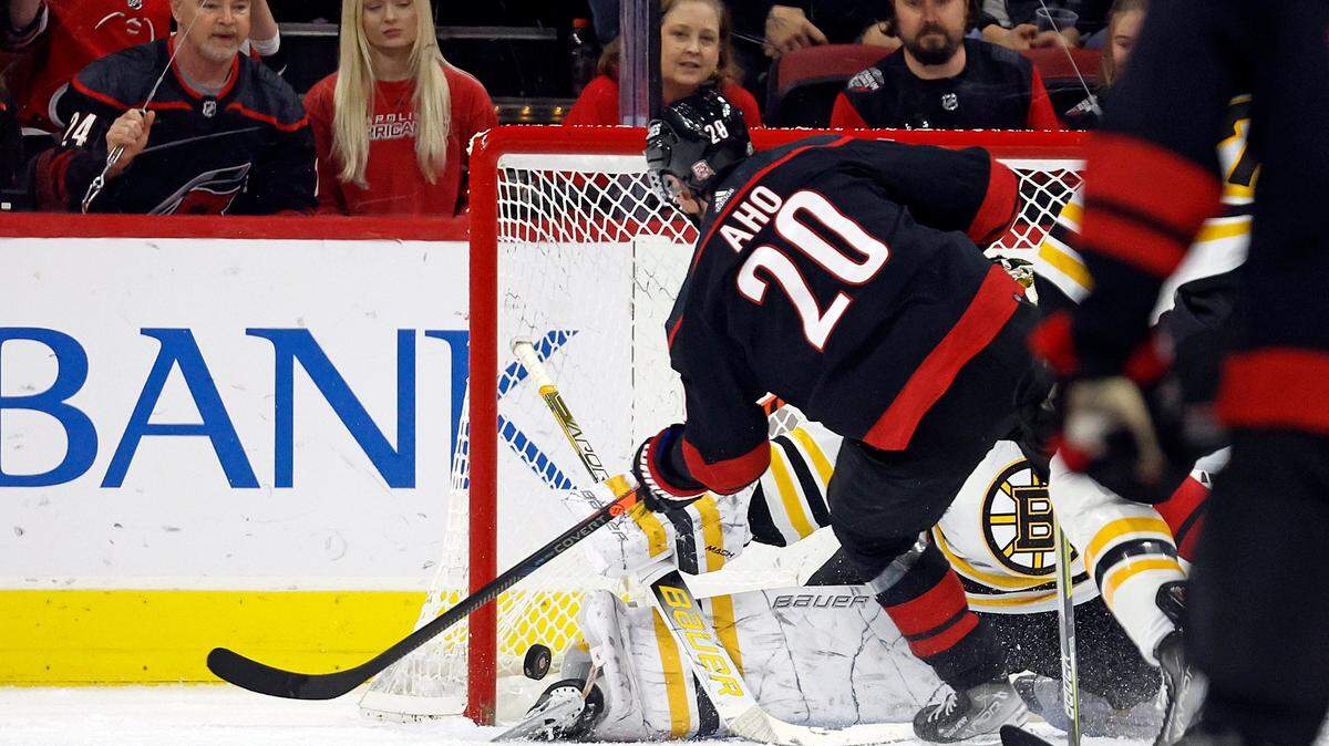 Carolina Hurricanes’ Sebastian Aho (20) shoots the puck past Boston Bruins goaltender Linus Ullmark (partially obscured) for a goal during the first period of an NHL hockey game in Raleigh, N.C., Sunday, Jan. 29, 2023. (AP Photo/Karl B DeBlaker)