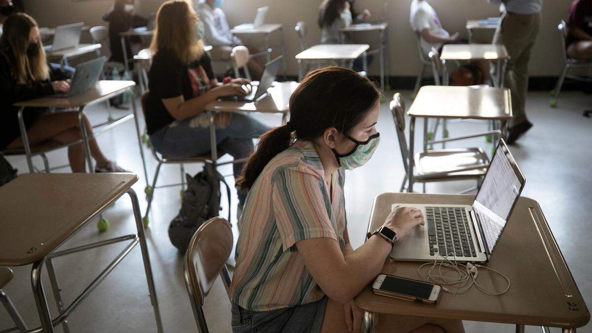 Broughton High School student Maggie Montgomery attends Marlin Jones’ American History class on Thursday, April 8, 2021 in Raleigh, N.C. More than 1,200 students returned for in-person classes on Thursday at Broughton.
