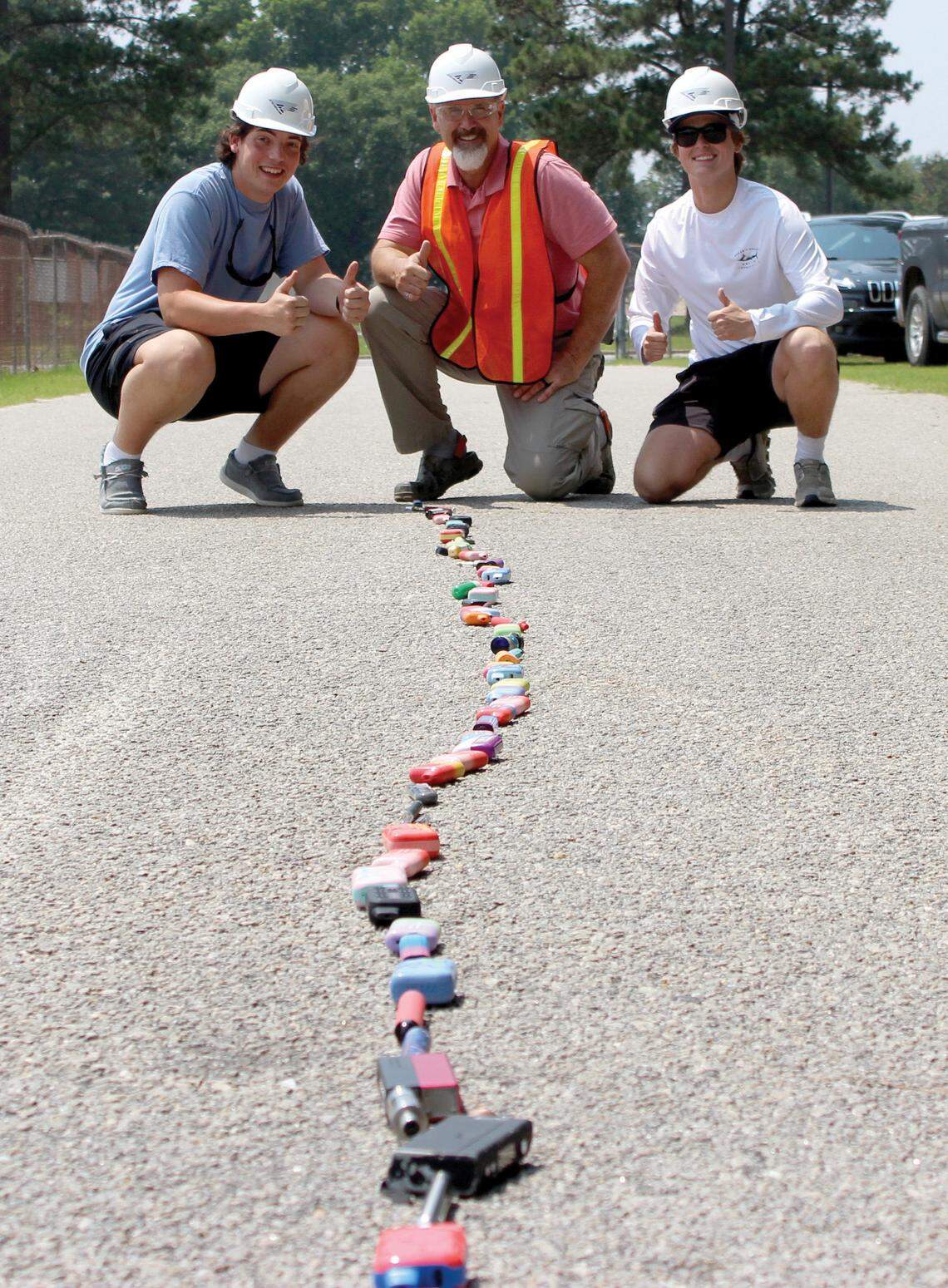 Students Michael Cole, left, and Hunter Thompson, right, get ready for the big vape crushing finale with teacher Gary Pierce.