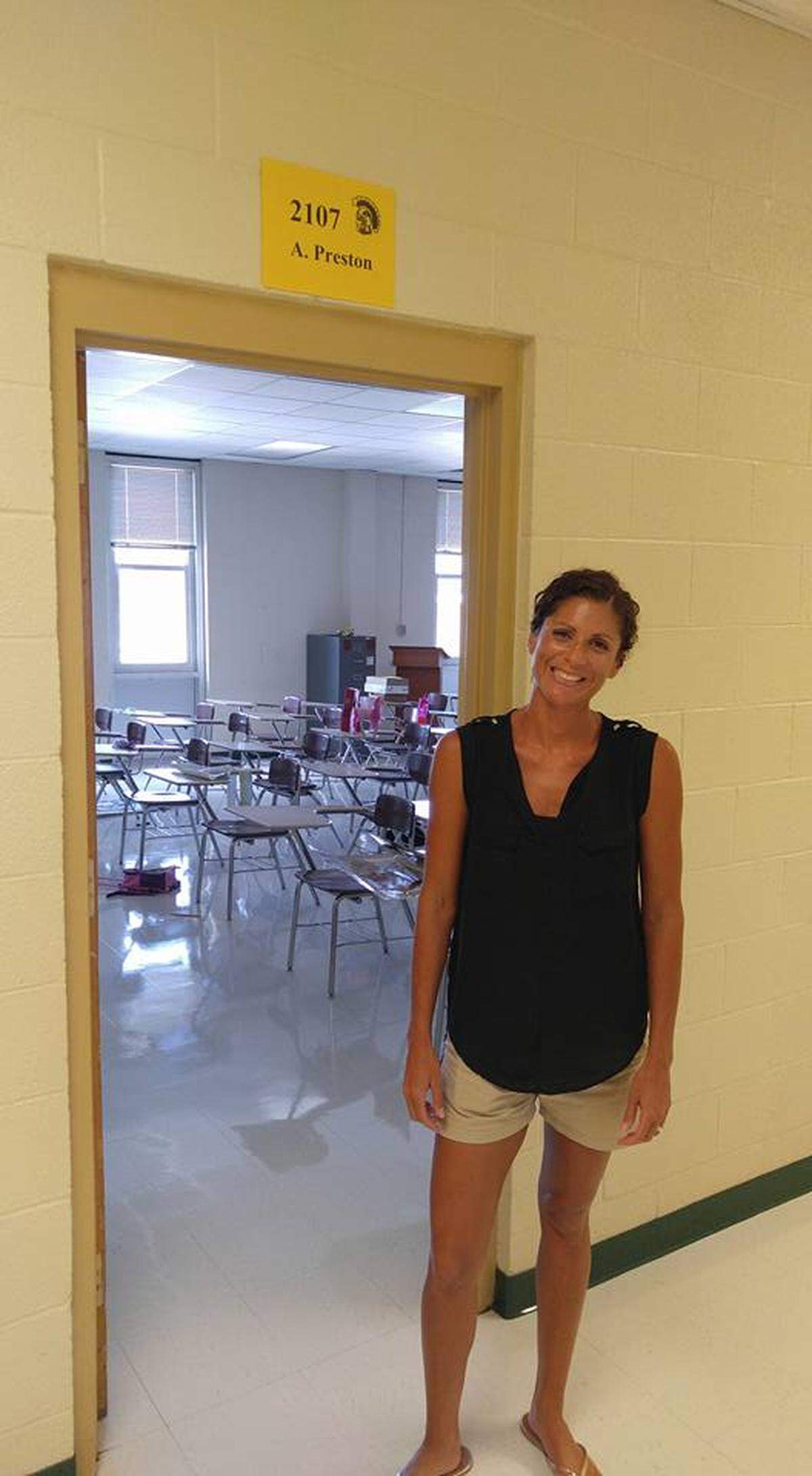 Aurora Preston, an English teacher at South Johnston High School, stands outside her classroom. She is refusing to follow the Johnston County school system’s requirement that face masks be worn in schools.