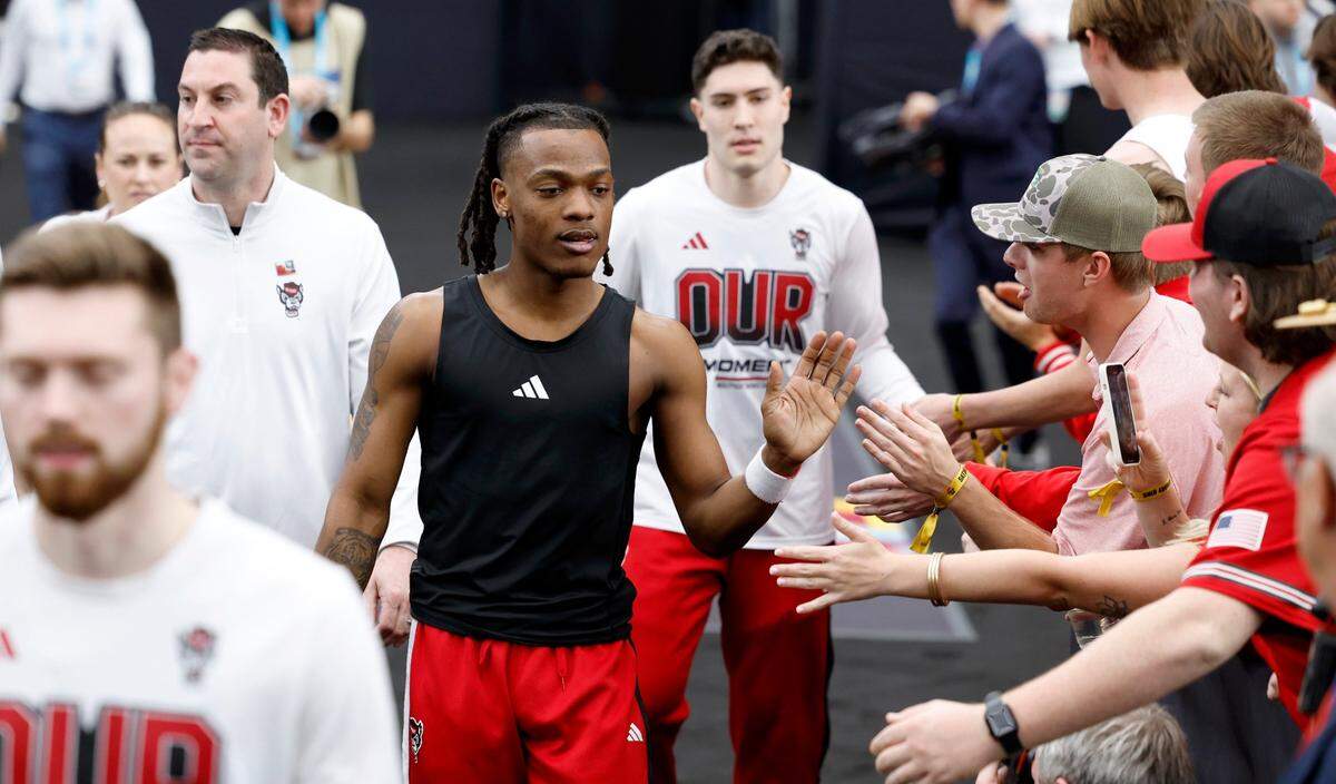 N.C. State’s DJ Horne and Michael O’Connell greet fans as they head to the court to warmup before N.C. State’s game against Purdue in the NCAA Tournament national semfinals at State Farm Stadium in Glendale, Ariz., Saturday, April 6, 2024.
