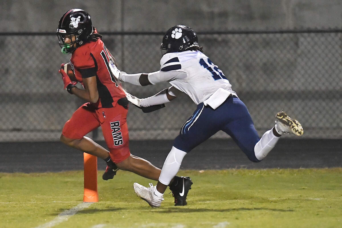 Rolesville wide receiver Anthony Roberts (15) runs for the touchdown against Millbrook free safety Zaire Hines (12) during the second half. The Rolesville Rams and the Millbrook Wildcats met in a football game in Raleigh. N.C. on October 11, 2024.
