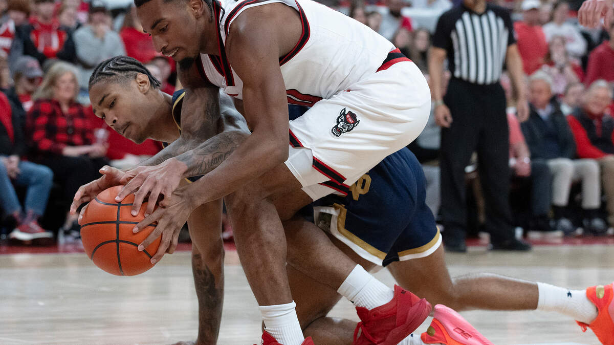 N.C. State’s Marcus Hill and Notre Dame’s Tae Davis scramble for a loose ball during the second half of the Wolfpack’s 66-65 win on Wednesday, Jan. 8, 2025, at Lenovo Center in Raleigh, N.C.