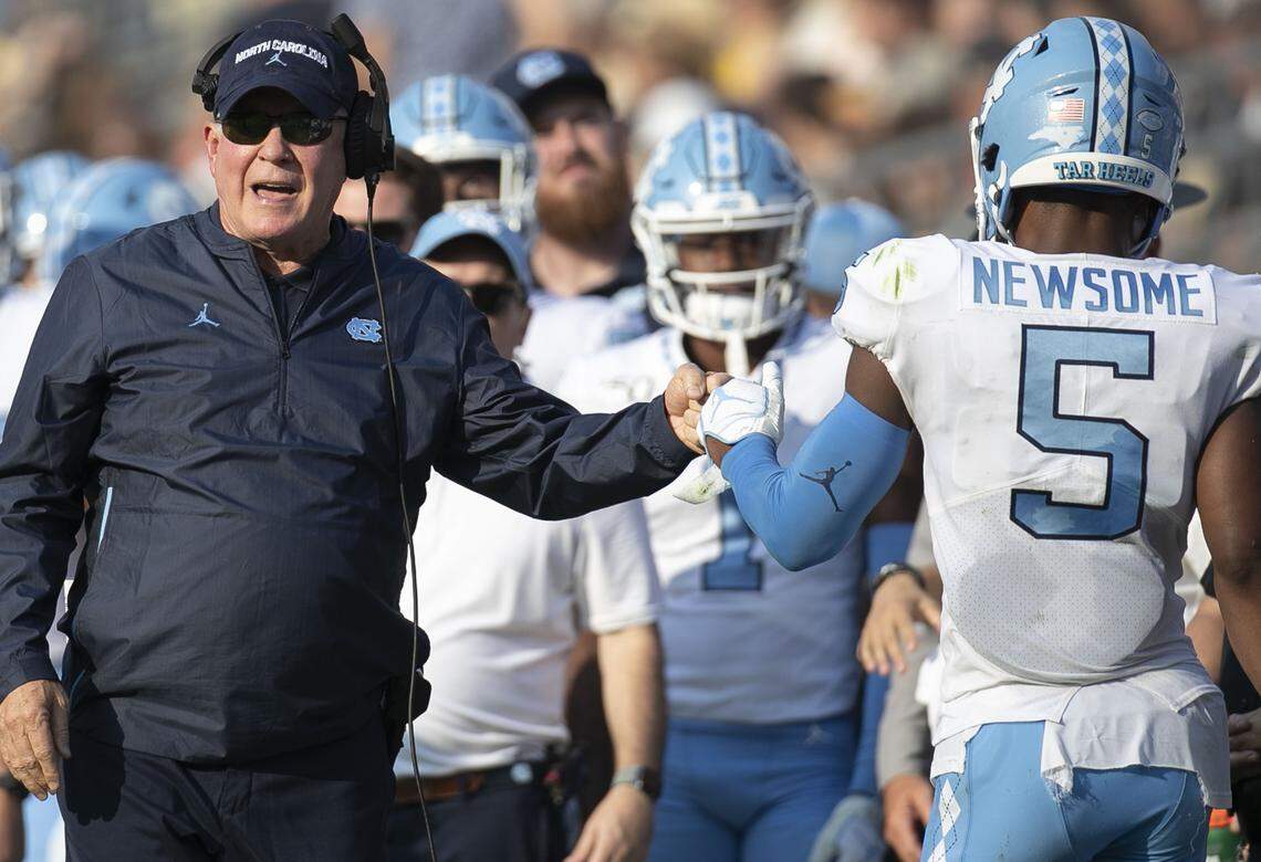North Carolina coach Mack Brown fist bumps Dazz Newsome (5) after the Tar Heels scored to take a 17-0 lead over Georgia Tech in the second quarter on Saturday, October 5, at Bobby Dodd Stadium in Atlanta, Georgia.