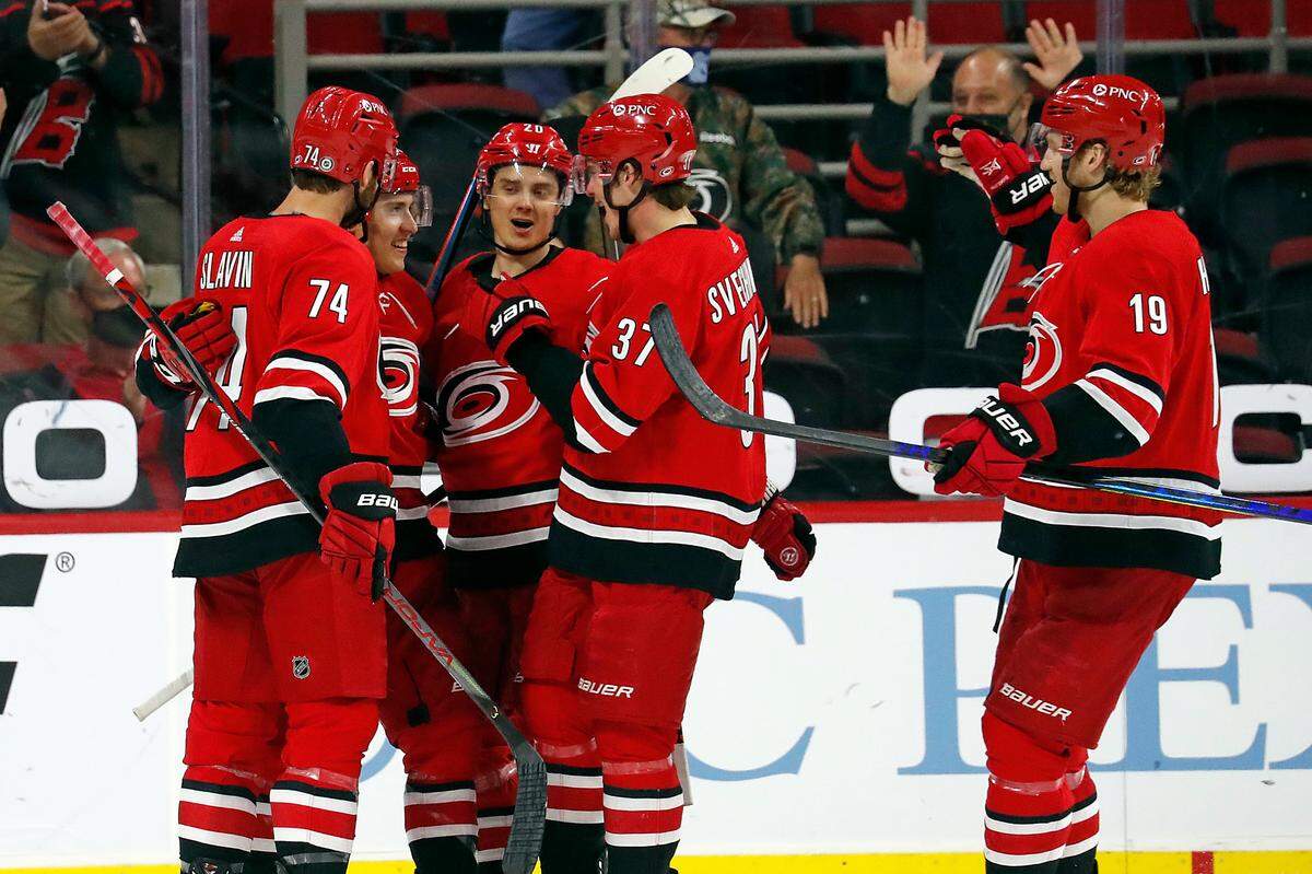 Carolina Hurricanes’ Teuvo Teravainen, second from left, is congratulated on his goal by Sebastian Aho (20), Andrei Svechnikov (37), Jaccob Slavin (74) and Dougie Hamilton (19) during the third period of an NHL hockey game against the Detroit Red Wings in Raleigh, N.C., Thursday, April 29, 2021. (AP Photo/Karl B DeBlaker)