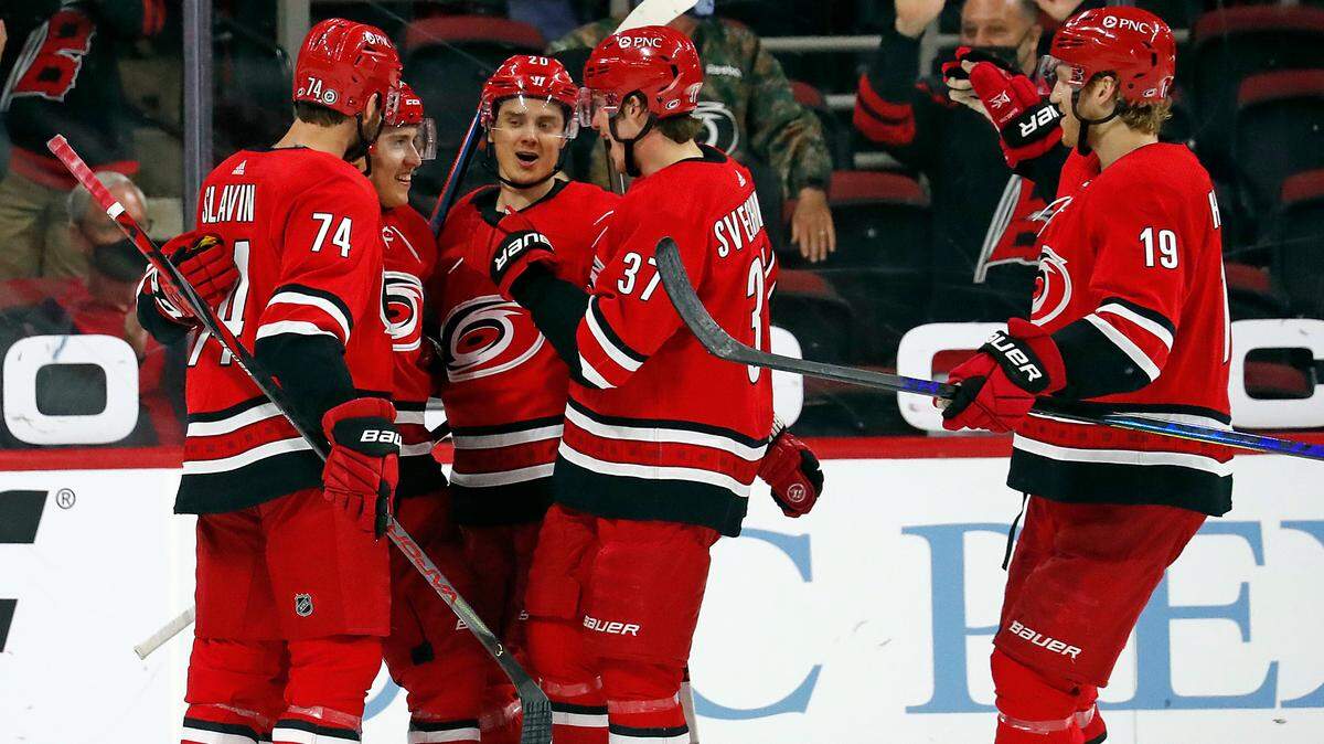 Carolina Hurricanes’ Teuvo Teravainen, second from left, is congratulated on his goal by Sebastian Aho (20), Andrei Svechnikov (37), Jaccob Slavin (74) and Dougie Hamilton (19) during the third period of an NHL hockey game against the Detroit Red Wings in Raleigh, N.C., Thursday, April 29, 2021. (AP Photo/Karl B DeBlaker)