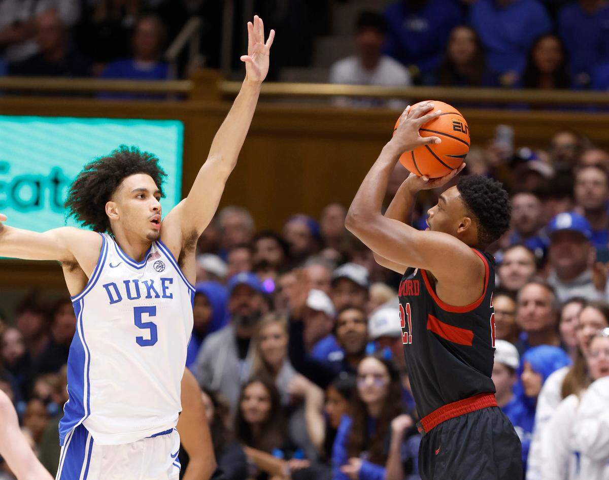 Stanford’s Jaylen Blakes (21) shoots as Duke’s Tyrese Proctor (5) defends during the first half of Duke’s game against Stanford at Cameron Indoor Stadium in Durham, N.C., Saturday, Feb. 15, 2025.