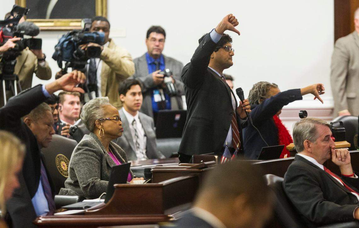 Democratic Senators including Jay J. Chaudhuri, a Raleigh Democrat, center, vote not to table an amendment to Senate Bill 4 during the North Carolina General Assembly’s fifth special session Wednesday, December 21, 2016, in the Senate chambers.