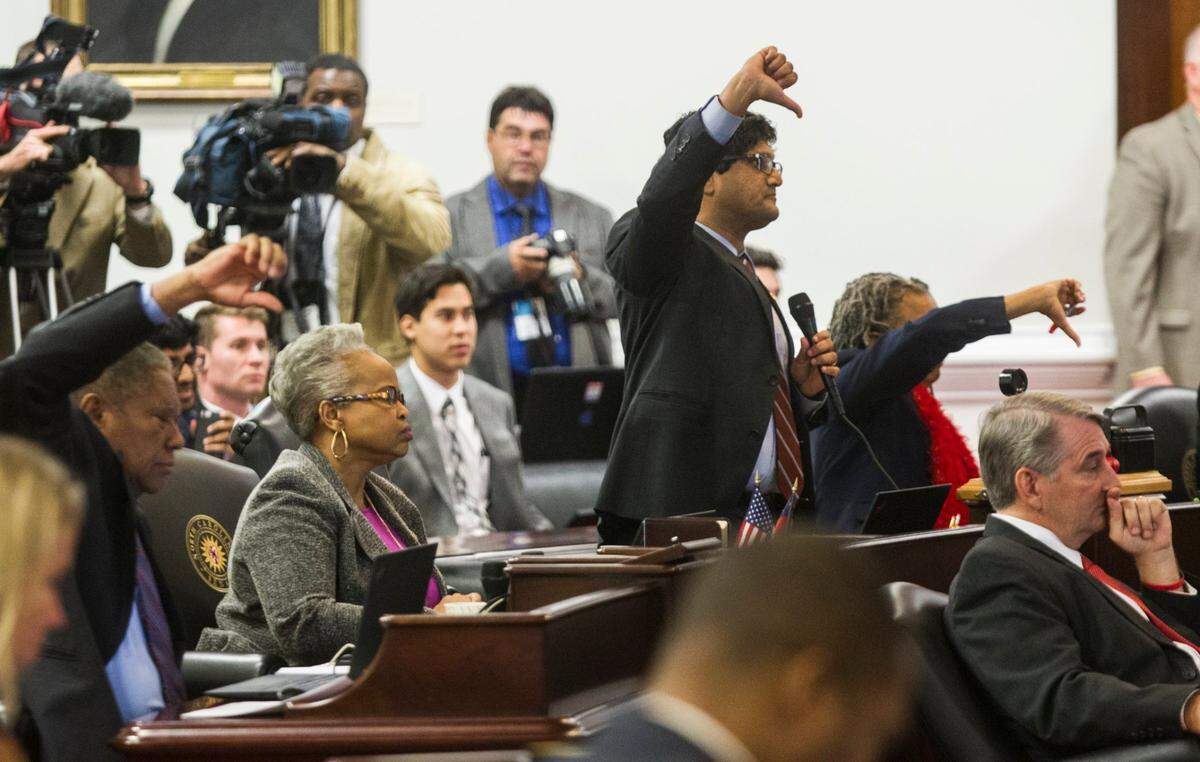 Democratic Senators including Jay J. Chaudhuri, a Raleigh Democrat, center, vote not to table an amendment to Senate Bill 4 during the North Carolina General Assembly’s fifth special session Wednesday, December 21, 2016, in the Senate chambers.