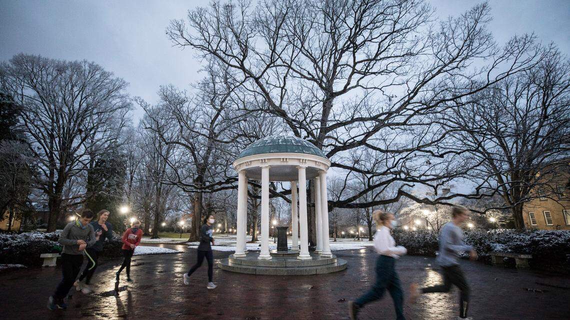 A group of UNC-Chapel Hill students in a running club start their morning run in a snowy scene on Thursday, January 28, 2021 at the Old Well in Chapel Hill, N.C. after a night of winter weather.