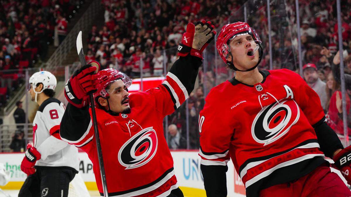 Dec 28, 2024; Raleigh, North Carolina, USA; Carolina Hurricanes center Sebastian Aho (20) celebrates his goal with center Seth Jarvis (24) against the New Jersey Devils during the third period at Lenovo Center. Mandatory Credit: James Guillory-Imagn Images