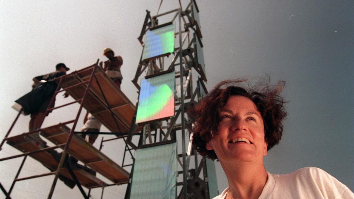 Roberta Lord, wife of deceased sculptor Dale Eldred, pauses for a moment during the installation of the Light + Time Tower on Capital Boulevard in 1995.