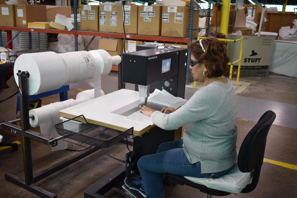 A Hickory Springs Manufacturing employee works on producing hospital gowns in one of the company’s North Carolina production plants in April 2019.