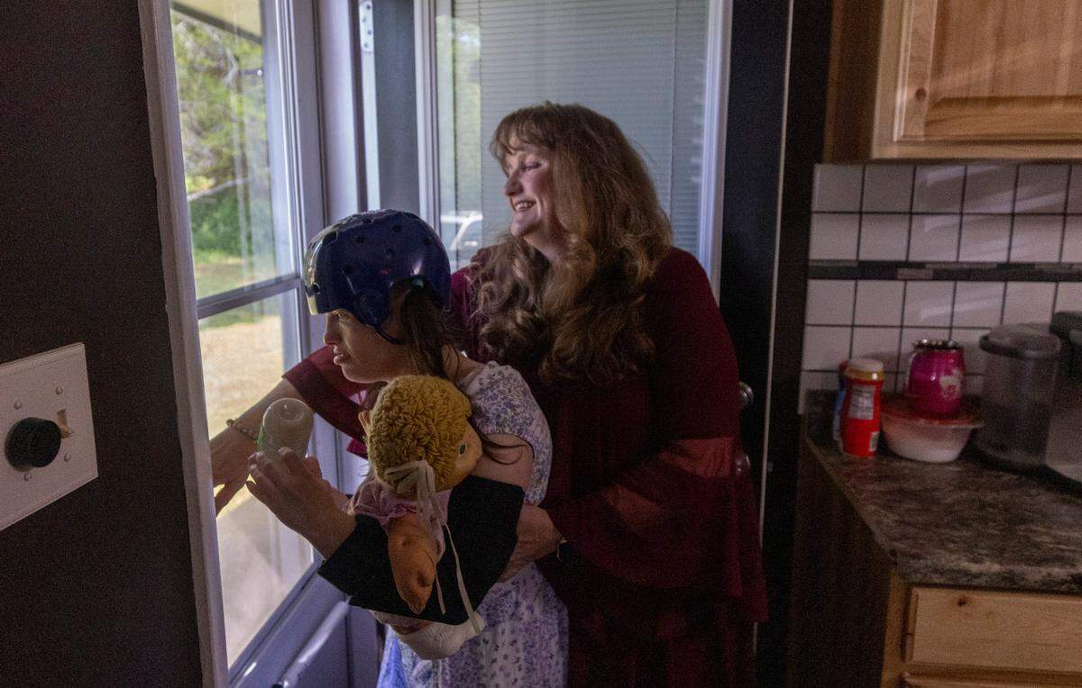 Dana Rhoney spends time with her daughter Samantha, who has a moving disorder and an intellectual disability, at their home near Claremont on Tuesday, April 23, 2024. The Rhoneys filed a lawsuit in 2017 that became known as the Samantha R. case. Disability Rights NC argued that the failure to provide access to community- and home-based behavioral health services violated the rights of people with disabilities.