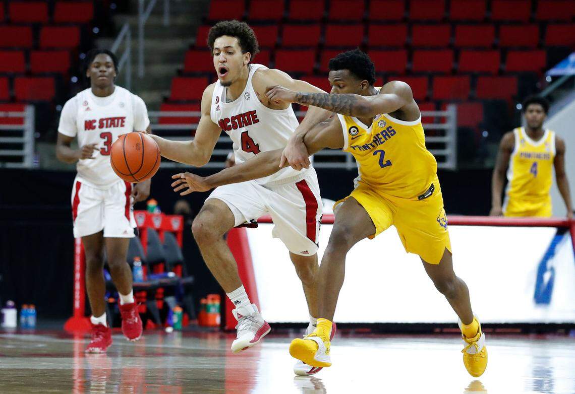 Pittsburgh’s Femi Odukale (2) fouls N.C. State’s Jericole Hellems (4) during the second half of N.C. State’s 65-62 victory over Pittsburgh at PNC Arena in Raleigh, N.C., Sunday, February 28, 2021.