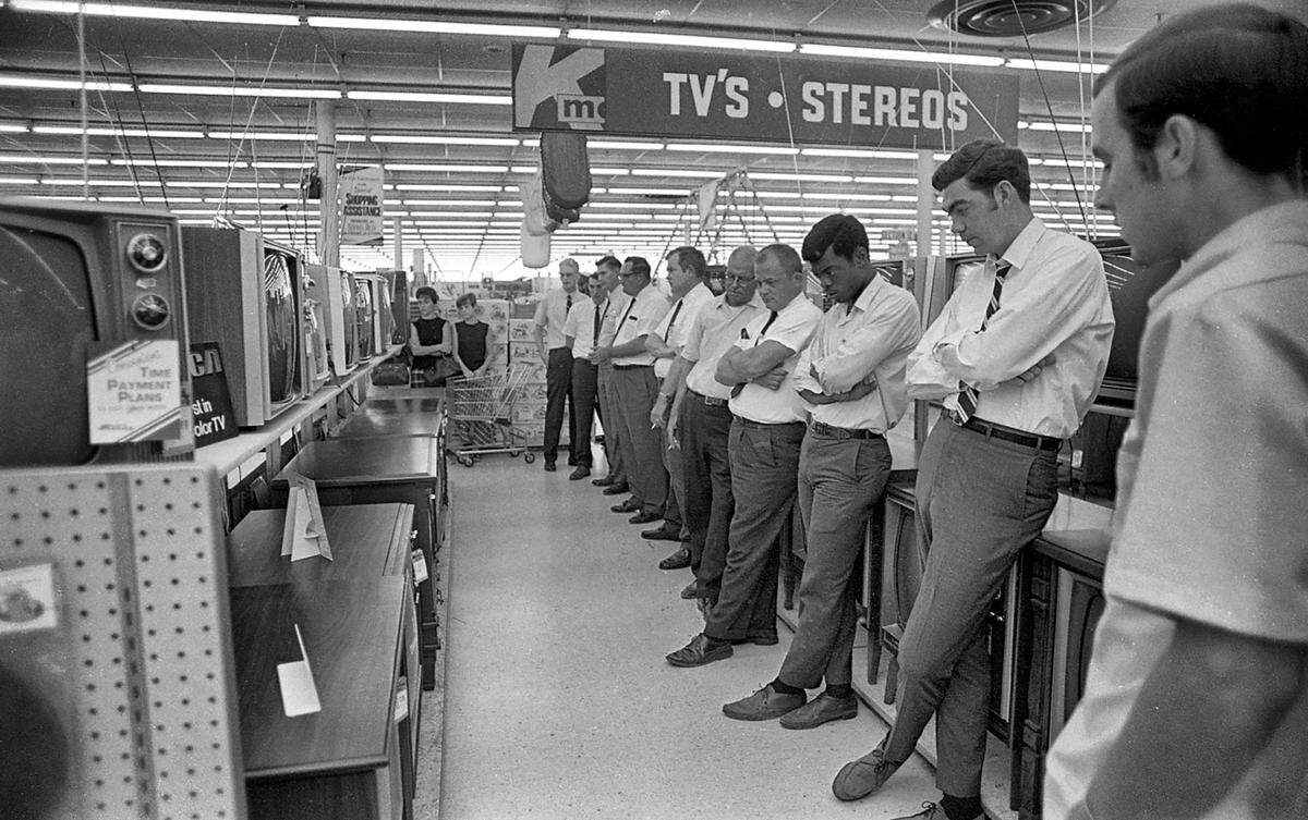 Employees at the K-Mart in Raleigh, N.C. watch the moon landing in the store, July 20, 1969.