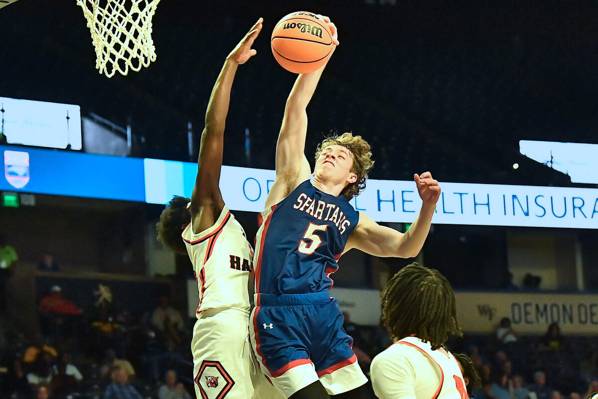 Sanderson’s Nathan Fife (5) Goes up for the shot against New Hanover’s Jazir Wright-Mcghee (14) during the second half. The Sanderson Spartans and the New Hanover Wildcats met in the NCHSAA 4A East Regional Final in Winston-Salem, N.C. on March 12, 2025.