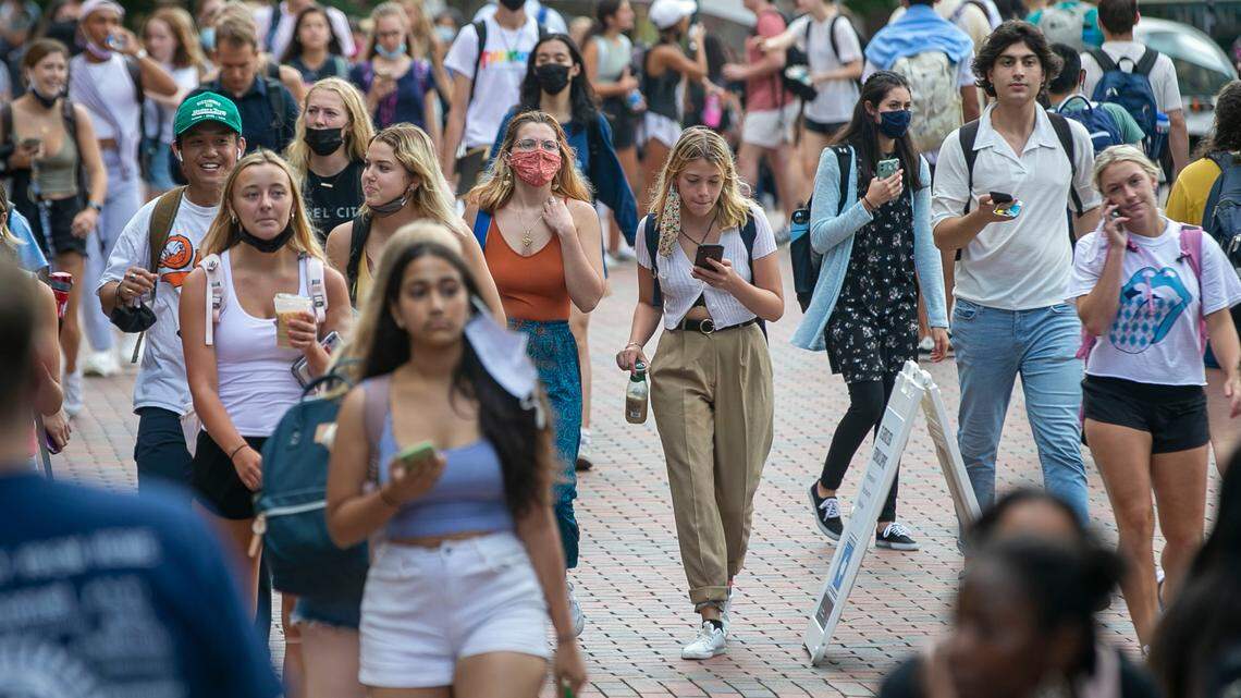 University of North Carolina students walk between the Student Union and Wilson Library on the first day of classes on August 18, 2021 in Chapel Hill, N.C.