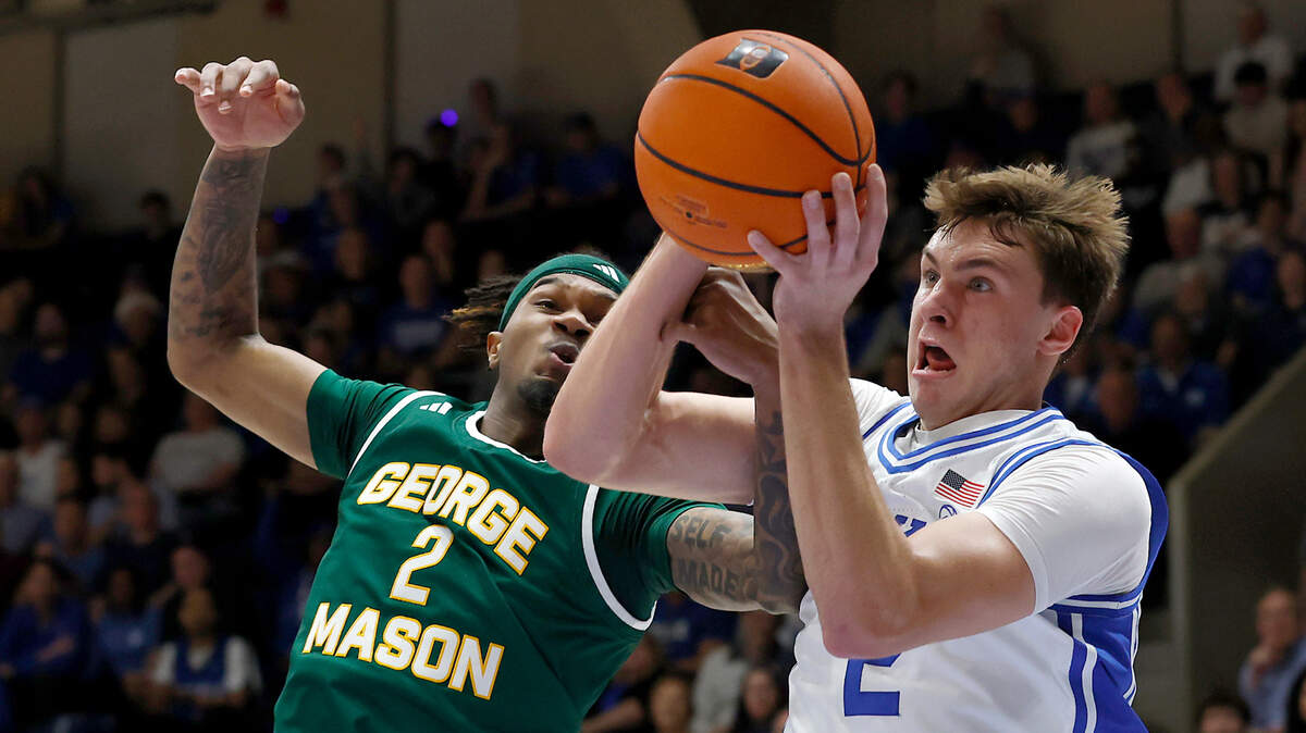 George Mason’s Woody Newton and Duke’s Cooper Flagg battle for a loose ball during the first half of the Blue Devils’ game on Tuesday, Dec. 17, 2024, at Cameron Indoor Stadium in Durham, N.C.