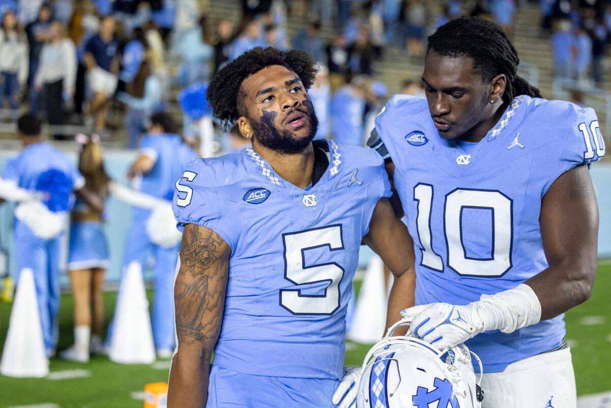 North Carolina’s Desmond Evans (10) consoles teammate Jahvaree Ritzie (5) following the Tar Heels’ 31-27 loss to Virginia on Saturday, October 21, 2023 at Kenan Stadium in Chapel Hill, N.C.