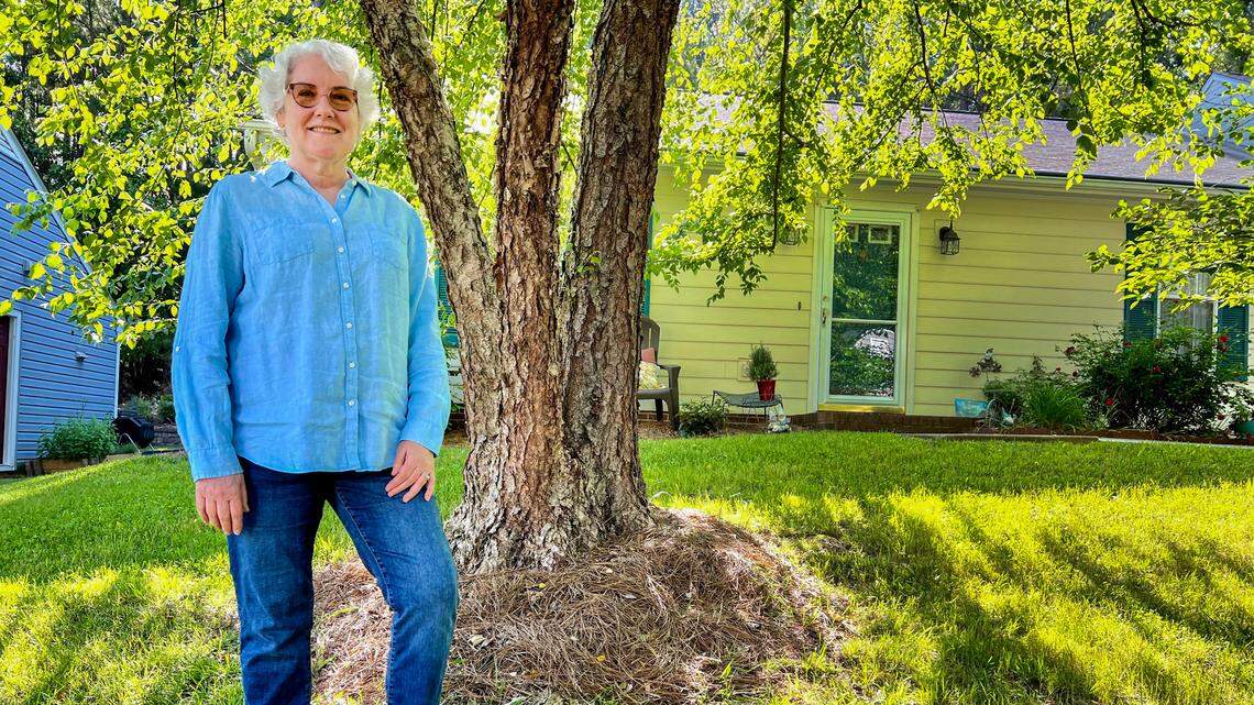 Rosemary Resler stands outside her home in Chapel Hill Thursday, May 23, 2024. She was recently dropped from her homeowners insurance because aarial photos showed roof damage on her property.