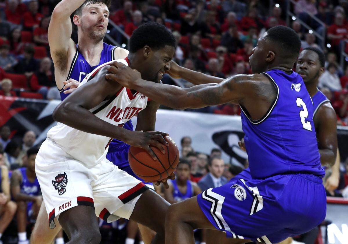 N.C. State’s DJ Funderburk (0) keeps the ball from Chowan’s Demetrius Sanders (2) during the first half of N.C. State’s exhibition game against Chowan at PNC Arena in Raleigh, N.C., Monday, Oct. 29, 2018.