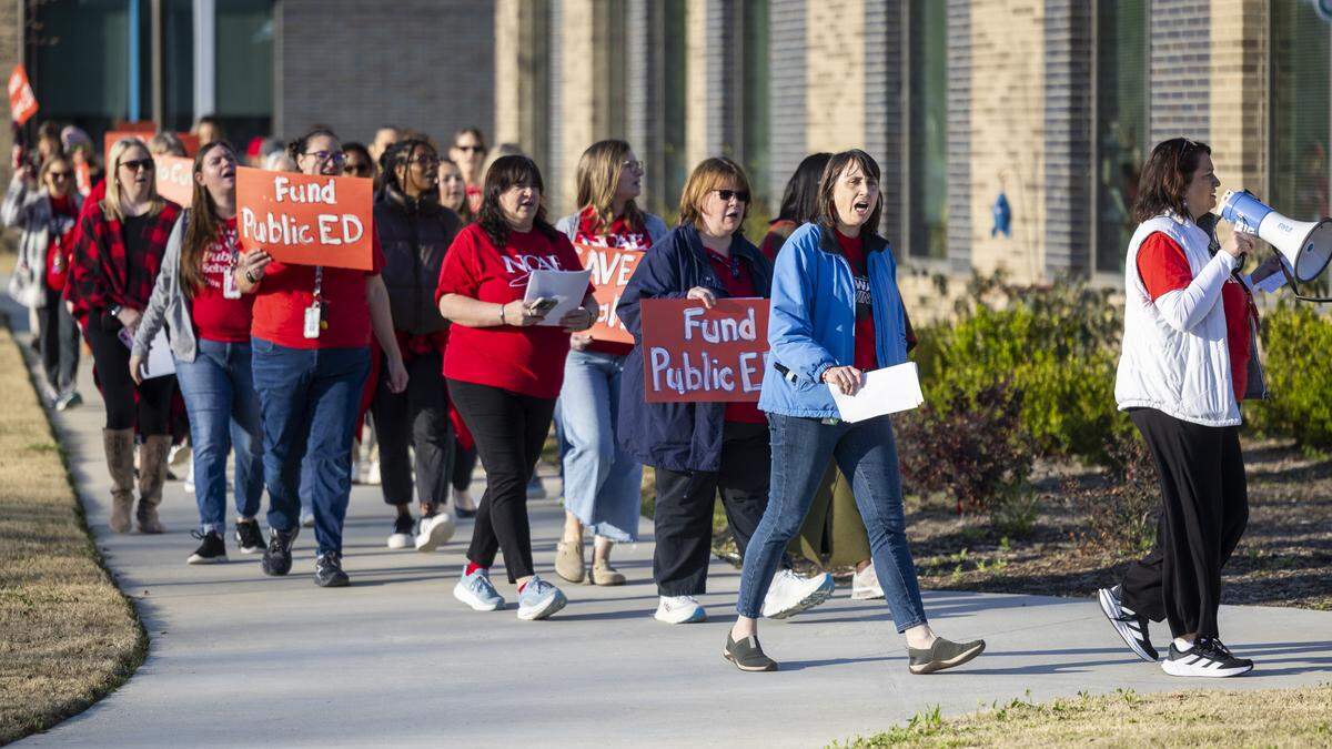 Educators and parents picket outside Fuquay-Varina Elementary School on Thursday, March 19, 2026, during a demonstration organized by the Wake County affiliate of the North Carolina Association of Educators. Protesters urged Wake County school leaders to prevent budget cuts that would reduce spending on special education programs.