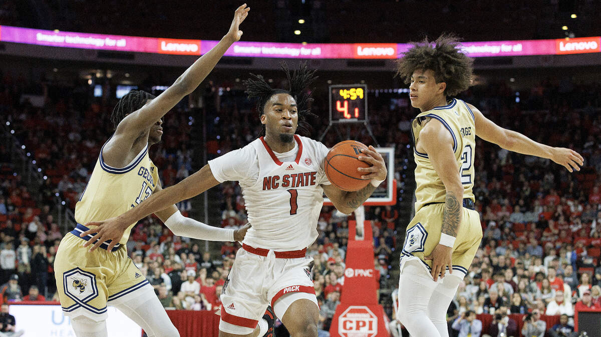 N.C. State’s Jayden Taylor drives between Georgia Tech’s Miles Kelly and Naithan George during the first half of the Wolfpack’s game on Saturday, Feb. 3, 2024, at PNC Arena in Raleigh, N.C.
