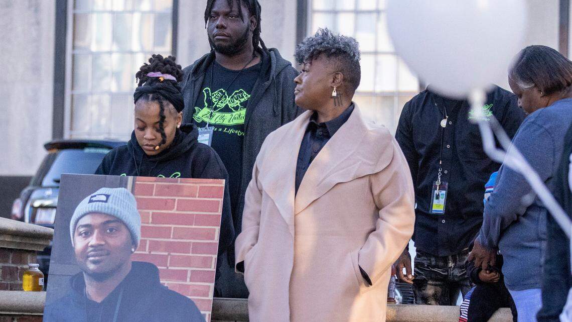During a Day of Remembrance for Gun-Related Homicide Victims ceremony in Durham Friday, Dec. 30, 2022, gun violence prevention advocates from Bull City United, from left, Latisha Williamson, Mario Melvin and Keshia Gray stand with a photograph of Reshaun Cates who was found shot to death in his car off Interstate 85 near Hillandale Road in October.