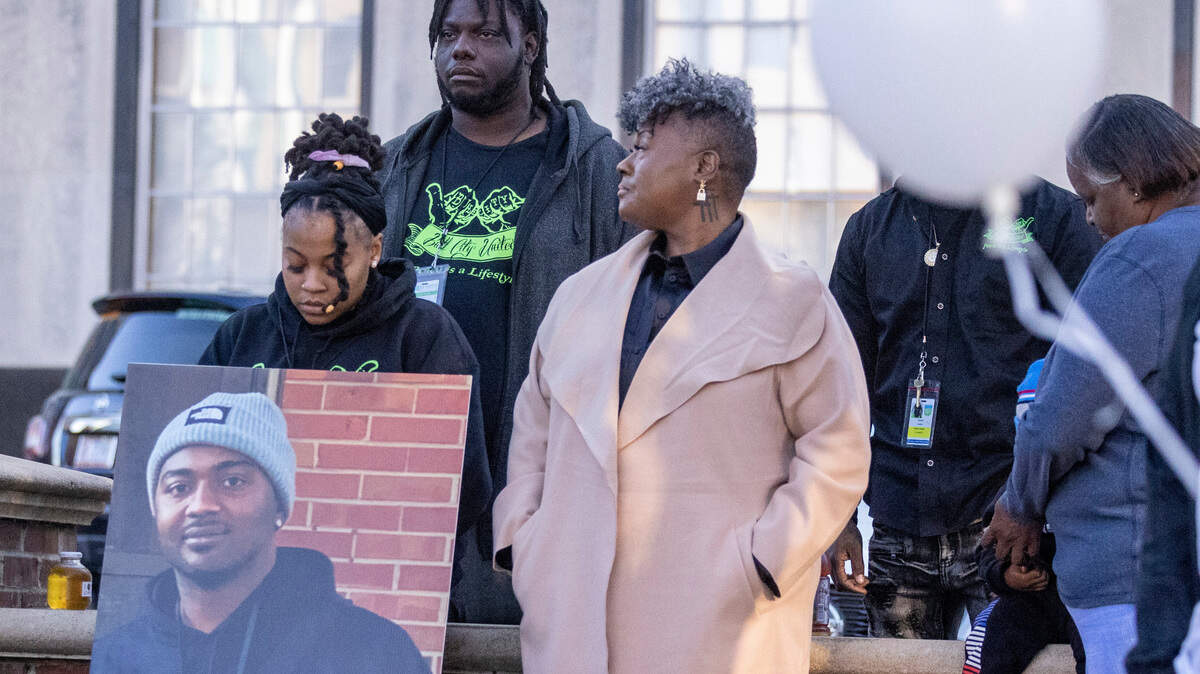 During a Day of Remembrance for Gun-Related Homicide Victims ceremony in Durham Friday, Dec. 30, 2022, gun violence prevention advocates from Bull City United, from left, Latisha Williamson, Mario Melvin and Keshia Gray stand with a photograph of Reshaun Cates who was found shot to death in his car off Interstate 85 near Hillandale Road in October.