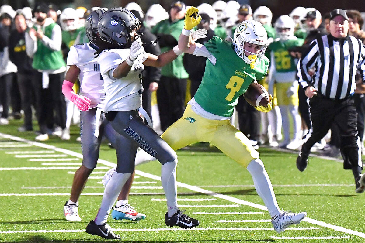 Cardinal Gibbons’ Brayden Karras (9)n runs for yardage against Hillside’s Erick Bonner (3) during the first half. The Cardinal Gibbons Crusaders and the Durham Hillside Hornets met in the third round of the NCHSAA 4A playoffs in Raleigh, N.C. on November 29, 2024.