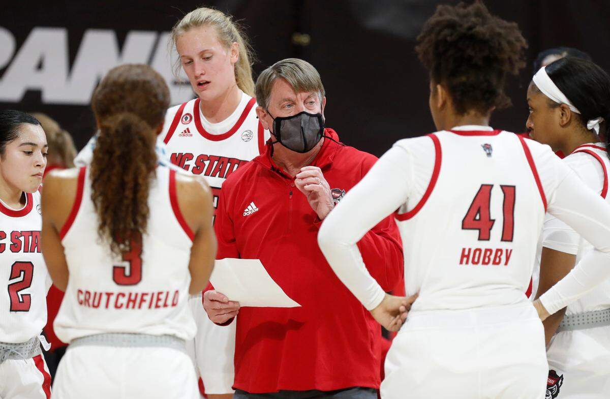 N.C. State head coach Wes Moore talks with his team during the first half of N.C. State’s game against Clemson at Reynolds Coliseum in Raleigh, N.C., Thursday, February 11, 2021.