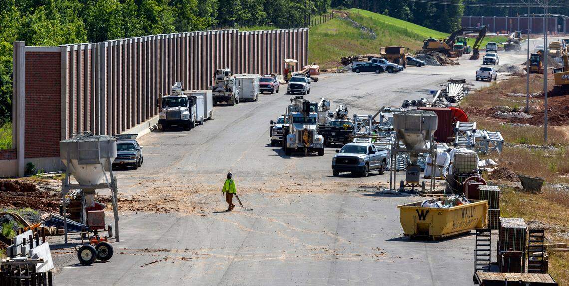 Work on N.C. 540 looking east from Sunset Lake Road toward Holly Springs Road on May 28, 2024. The noise reduction wall will be completed before the new toll road opens this summer.