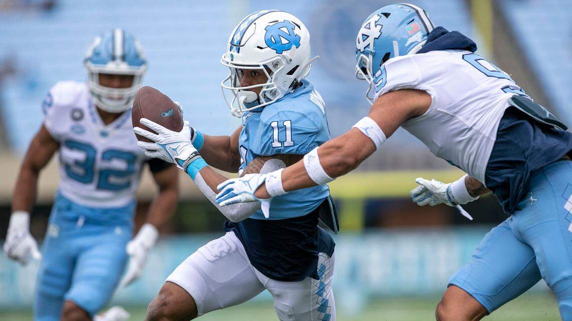 North Carolina’s Josh Downs (11) heads to the end zone for a touchdown after a pass reception from quarterback Jacolby Criswell (6) during the Tar Heels’ spring football game on Saturday, April 9, 2022 at Kenan Stadium in Chapel Hill, N.C.