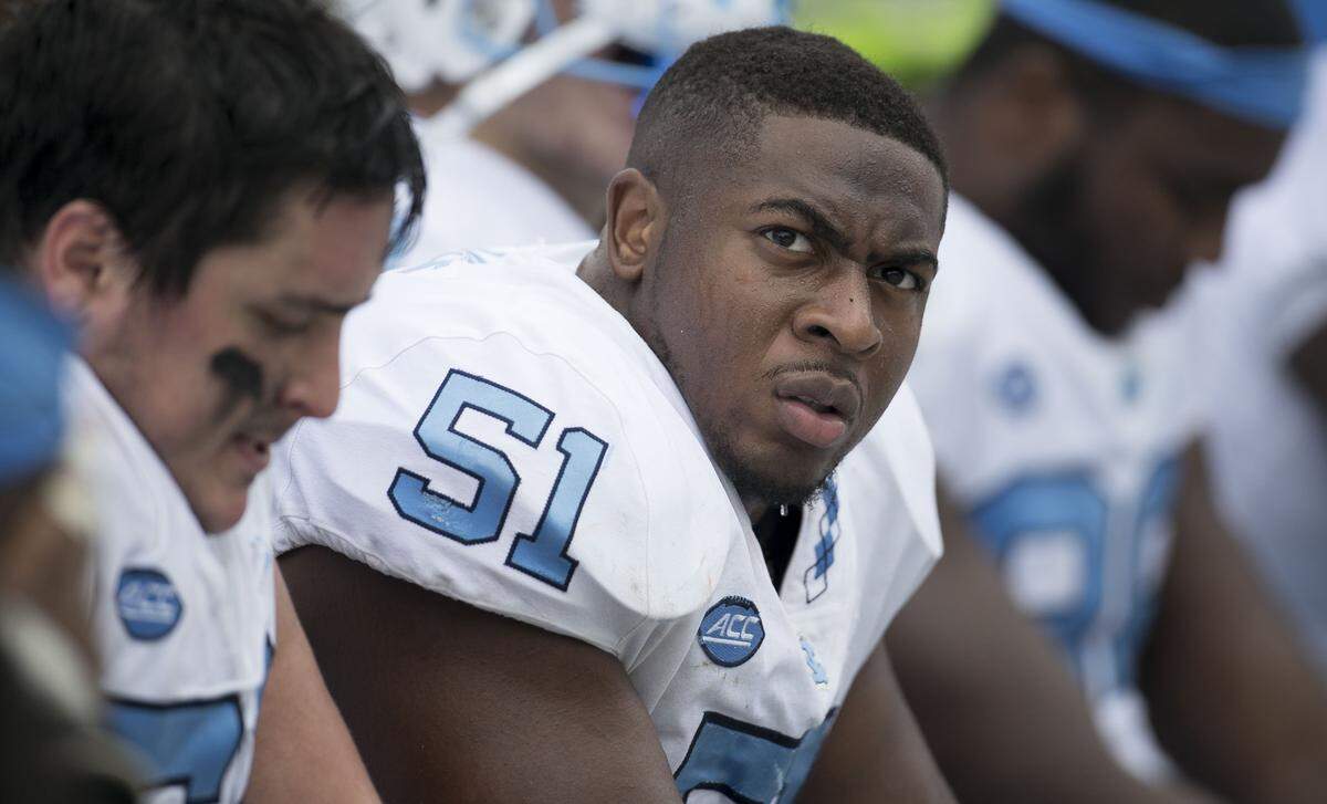 North Carolina’s William Sweet (51) and his teammates watch the final minute of play as Virginia runs out the clock to secure their 21-31 victory over North Carolina on Saturday, October 27, 2018 at Scott Stadium in Charlottesville, Va.