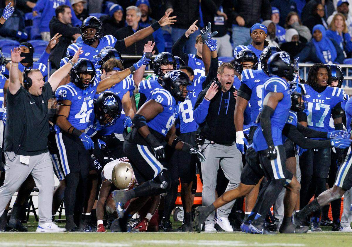 The Duke sideline celebrates after stopping Florida State on third down late in the fourth quarter of the Blue Devils’ 23-16 win on Friday, Oct. 18, 2024, at Wallace Wade Stadium in Durham, N.C.