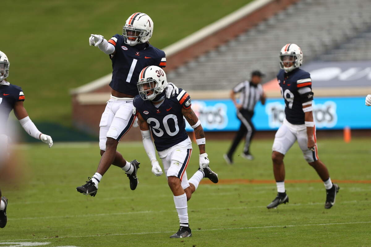 Virginia Cavaliers cornerback Nick Grant (1) and Virginia Cavaliers safety D’Angelo Amos (30) celebrate during the first game of the season against Duke Blue Devils on Saturday at Scott Stadium.