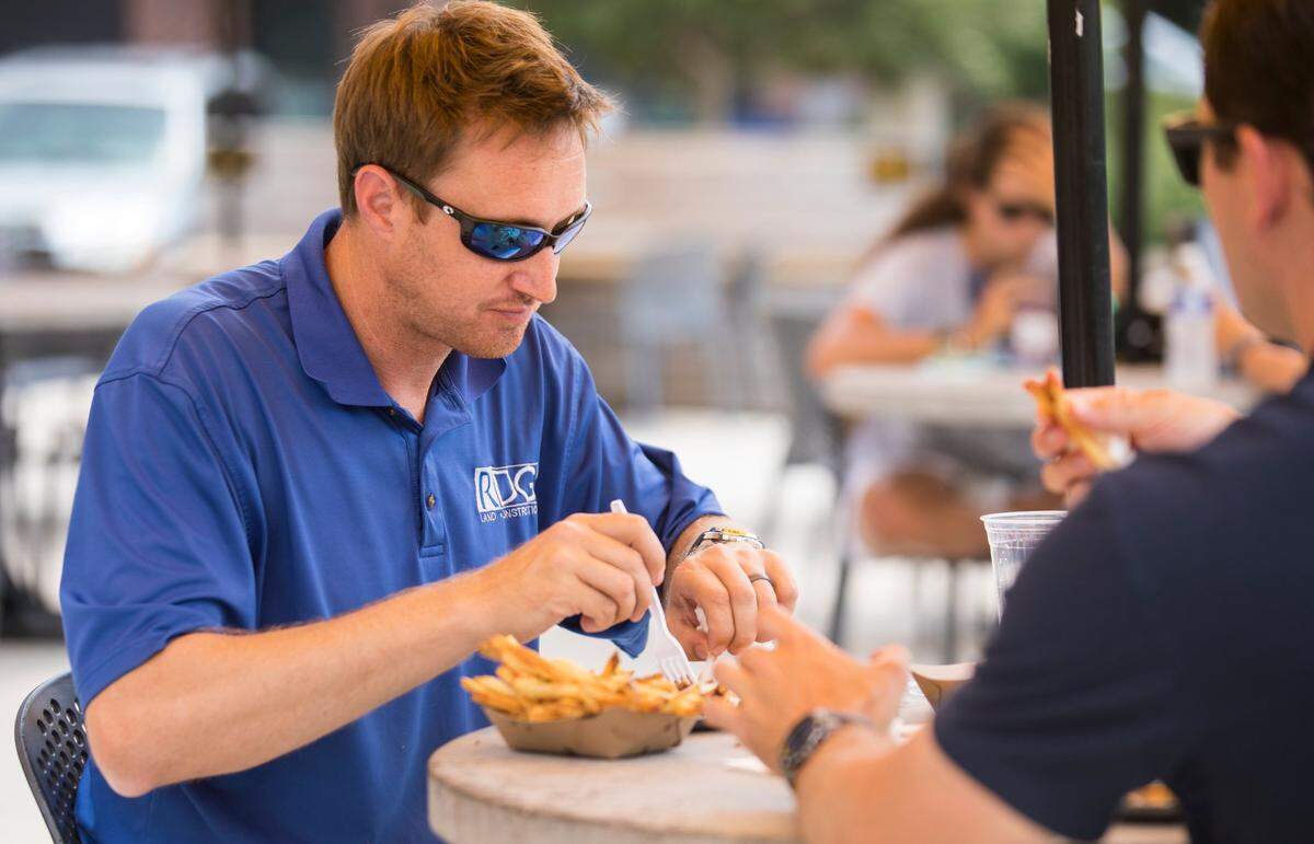 Chris Hodges eats lunch outside at Transfer Co. Food Hall in Raleigh, N.C. on Thursday, July 22, 2021.