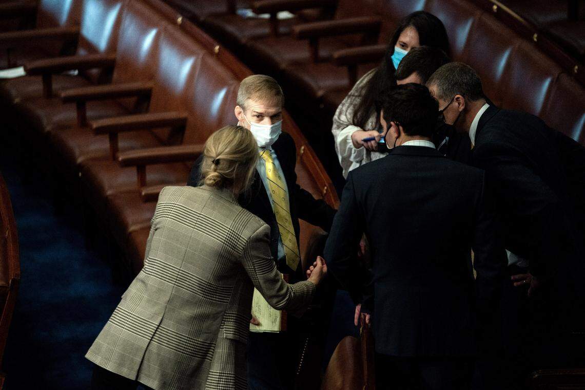 Rep. Jim Jordan (R-Ohio) confers with fellow House Republicans as the vote to impeach President Donald Trump passes 232 to 197 at the Capitol on Wednesday, Jan. 13, 2021. The House voted on an article of impeachment that accuses Trump of “incitement of insurrection,” and 10 Republicans supported the move.