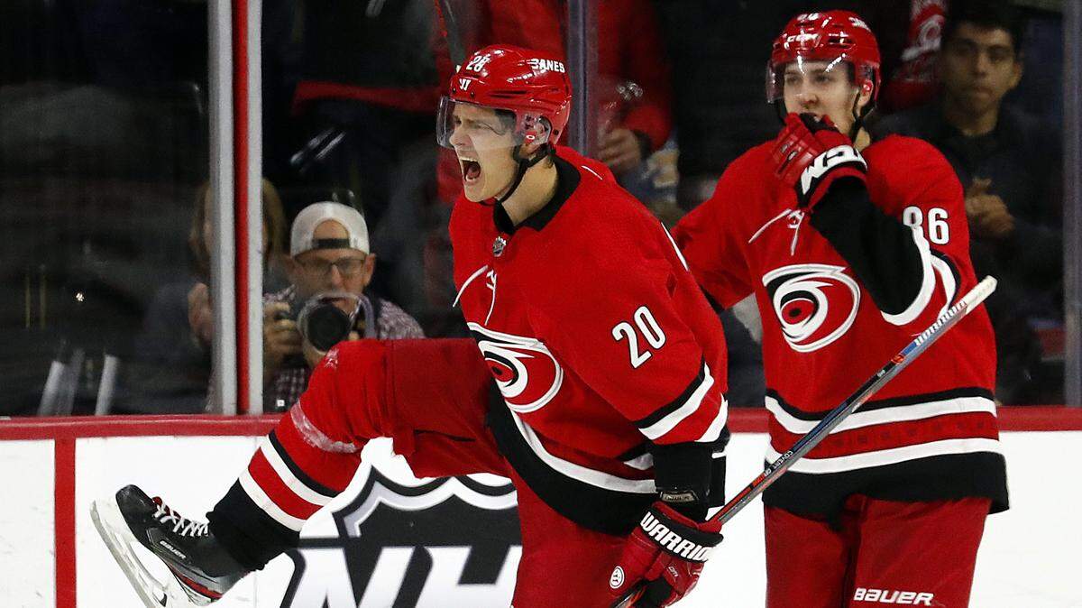 Carolina Hurricanes forward Sebastian Aho (20) celebrates his score-tying goal with teammate Teuvo Teravainen (86) in the third period of a 4-3 overtime loss to the Edmonton Oilers in February 2020.
