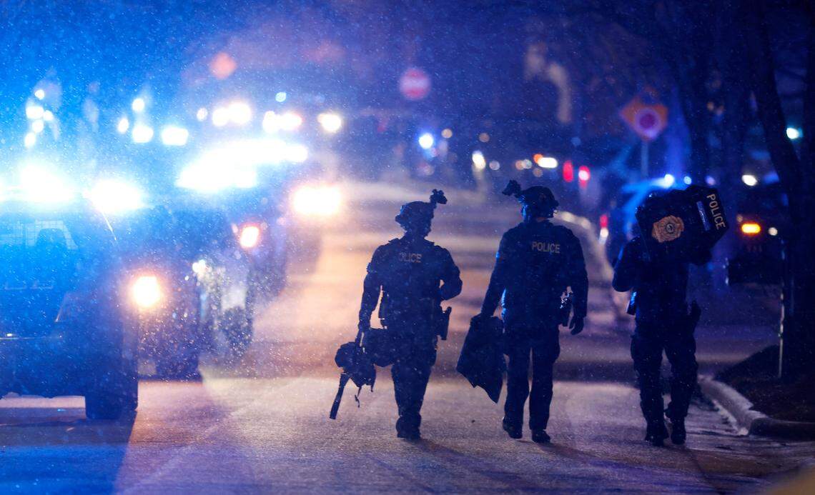 Officers walk on Chapanoke Road after responding to a shooting in the 600 block of Democracy Street in Raleigh, N.C., Tuesday evening, Jan. 21, 2025. Police confirmed that one officer was shot and transported to WakeMed with serious injuries and that the suspect is dead.