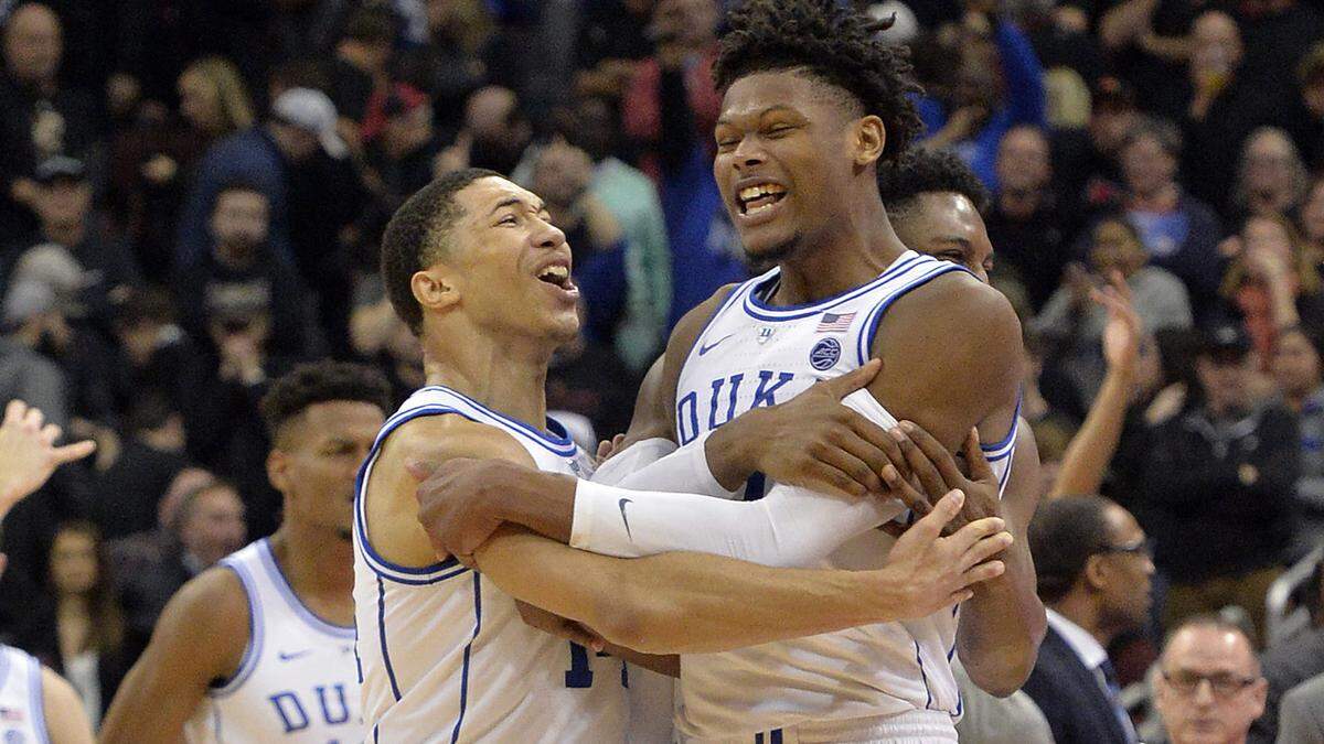 Duke guard Jordan Goldwire, left, and forward Cam Reddish celebrate following the team’s 71-69 victory over Louisville in an NCAA college basketball game in Louisville, Ky., Tuesday, Feb. 12, 2019. (AP Photo/Timothy D. Easley)
