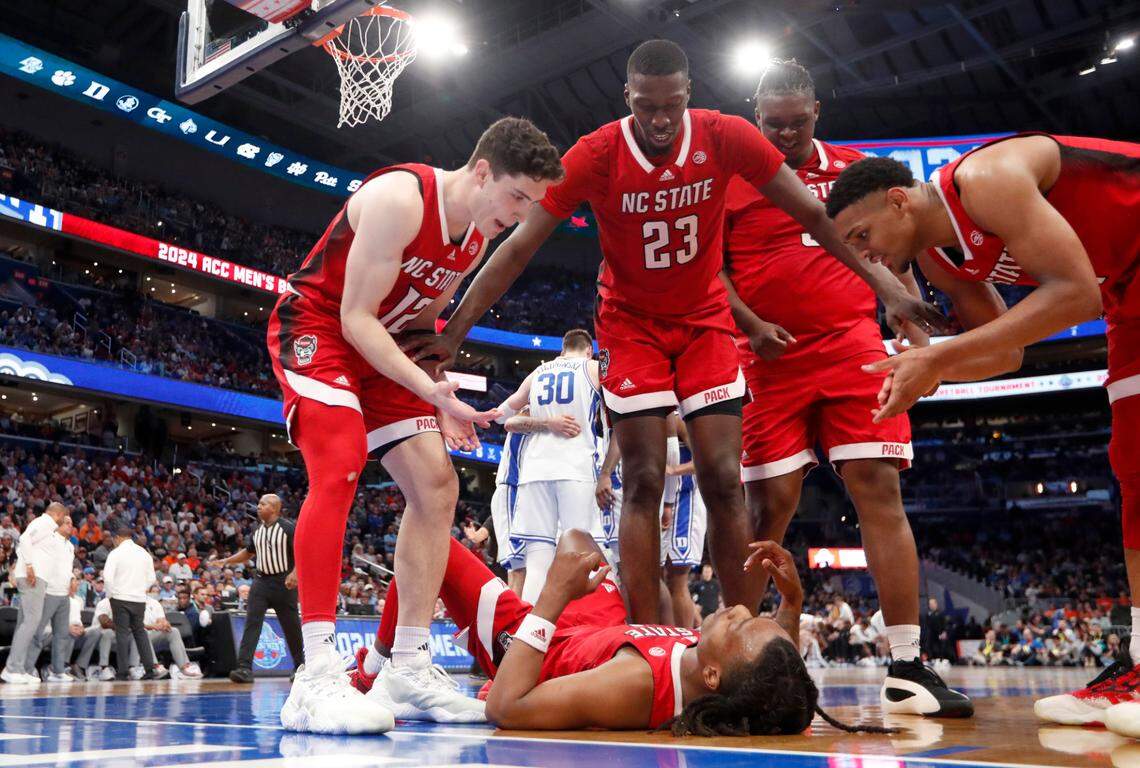 N.C. State’s Michael O’Connell (12), Mohamed Diarra (23), DJ Burns Jr. (30) and Casey Morsell (14) get ready to help up DJ Horne (0) after he was fouled during N.C. State’s 74-69 victory over Duke in the quarterfinal round of the 2024 ACC Men’s Basketball Tournament at Capital One Arena in Washington, D.C., Thursday, March 14, 2024.