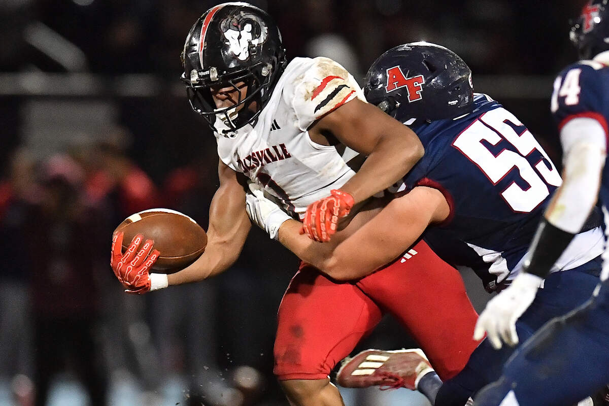 Apex Friendship's Landon Davis (55) tackles Rolesville running back Amir Brown (2) during the second half. The Apex Friendship Patriots and the Rolesville Rams met in  the second round of the  NCHSAA 8A Playoff game in Apex, N.C. on November 14, 2025. Rolesville wins 14-7 in overtime.