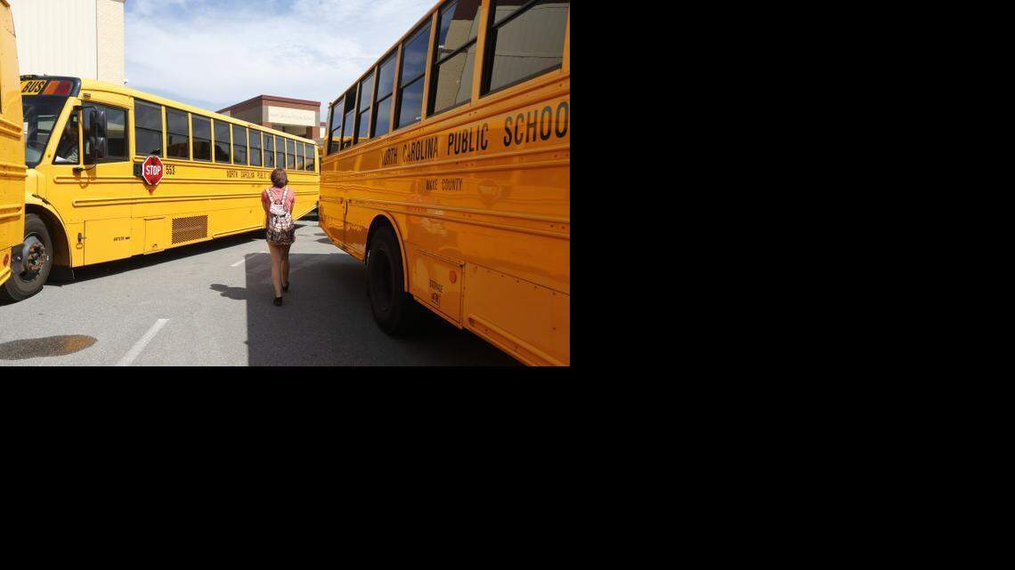 A student navigates the buses ready to take kids home at Holly Grove Middle School Wednesday afternoon, August 20, 2014, in Holly Springs.
