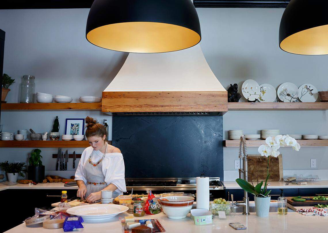 Melina Kuehn, 16, prepares food in the kitchen of the Andrews-Duncan House prior to a fundraising event for CASA, an affordable housing nonprofit, on Tuesday, May 16, 2023, in Raleigh, N.C.
