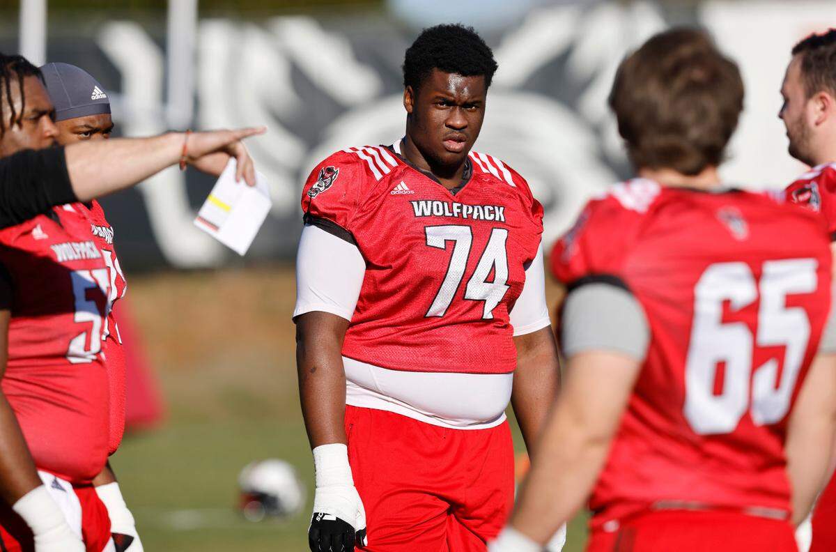 N.C. State offensive lineman Anthony Belton (74) listens to instructions during the first day of the Wolfpack’s spring football practice in Raleigh, N.C., Wednesday, March 2, 2022.