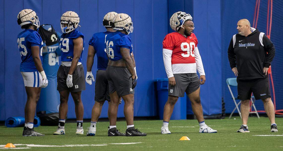 Duke defensive tackle DeWayne Carter (90) talks with defensive line coach Jess Simpson during the Blue Devils’ spring practice on Friday, March 24, 2023 in Durham, N.C.